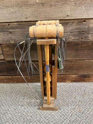 OLD CROQUET SET AND WOODEN STAKED YARD ART HOSE HOLDER