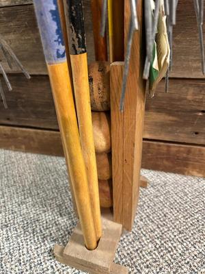 OLD CROQUET SET AND WOODEN STAKED YARD ART HOSE HOLDER
