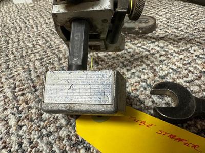 FORD MOTOR CO AIR PUMP AND WRENCH PLUS AN OLD TUBE STRAPPER