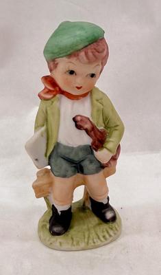 Sale Photo Thumbnail #222: Boy holding sheet music and a violin. Bisque ceramic made in Taiwan for Action.  Good condition, approx. 4.5" tall.