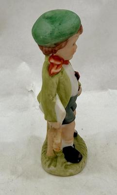 Sale Photo Thumbnail #223: Boy holding sheet music and a violin. Bisque ceramic made in Taiwan for Action.  Good condition, approx. 4.5" tall.