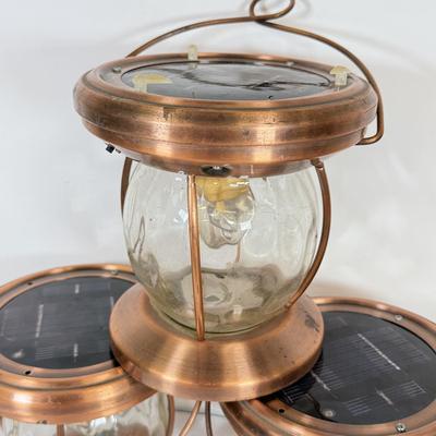 LOT 67: Three Copper & Brass Solar Powered Lanterns`