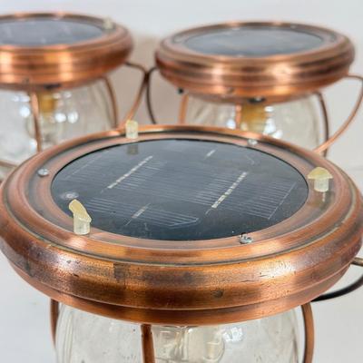 LOT 67: Three Copper & Brass Solar Powered Lanterns`