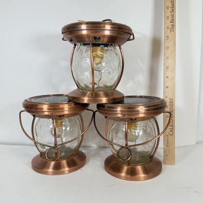 LOT 67: Three Copper & Brass Solar Powered Lanterns`
