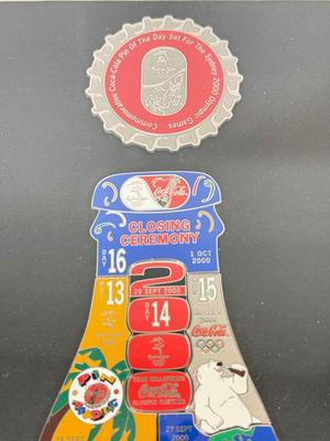 LOT 110: Framed Limited Edition Coca-Colay Sydney 2000 Olympics Bottle Puzzle Pin Set