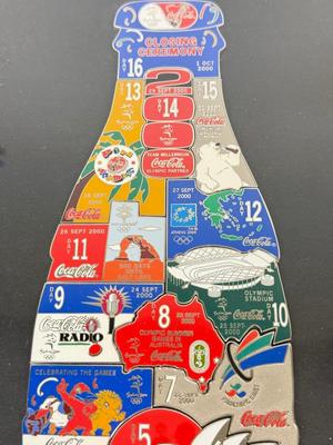 LOT 110: Framed Limited Edition Coca-Colay Sydney 2000 Olympics Bottle Puzzle Pin Set