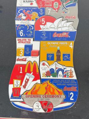 LOT 110: Framed Limited Edition Coca-Colay Sydney 2000 Olympics Bottle Puzzle Pin Set