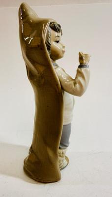 Sale Photo Thumbnail #606: Lladro "Boy with Snails" porcelain figurine, model number 4896. Approx. 9" tall.Release in 1974 and retired in 1979.