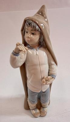 Sale Photo Thumbnail #602: Lladro "Boy with Snails" porcelain figurine, model number 4896. Approx. 9" tall.Release in 1974 and retired in 1979.