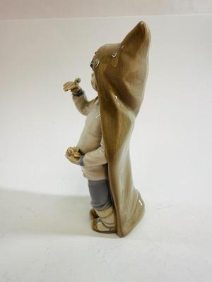 Sale Photo Thumbnail #604: Lladro "Boy with Snails" porcelain figurine, model number 4896. Approx. 9" tall.Release in 1974 and retired in 1979.