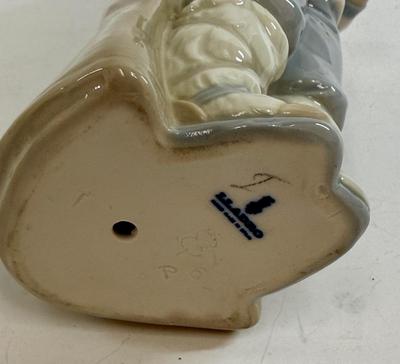 Sale Photo Thumbnail #603: Lladro "Boy with Snails" porcelain figurine, model number 4896. Approx. 9" tall.Release in 1974 and retired in 1979.