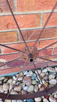IRON WHEEL AND A ROUND CAST IRON DISC WITH A LIP