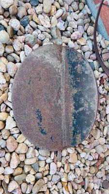 IRON WHEEL AND A ROUND CAST IRON DISC WITH A LIP
