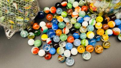 UNOPENED PACKAGE OF 100 MARBLES AND A JAR OF MISC MARBLES