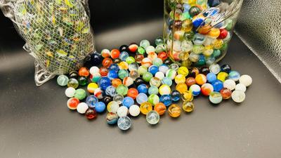 UNOPENED PACKAGE OF 100 MARBLES AND A JAR OF MISC MARBLES