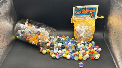 A JAR OF MISC MARBLES AND AN UNOPENED PACKAGE