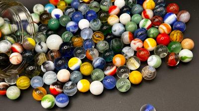 A JAR OF MISC MARBLES AND AN UNOPENED PACKAGE