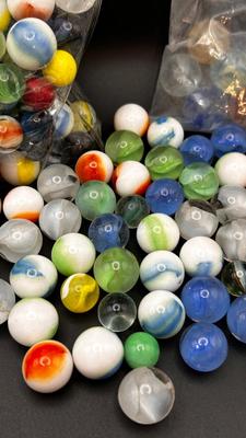 2 UNOPENED BAGS OF MARBLES AND SOME MISC