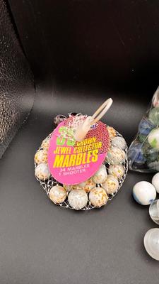 2 UNOPENED BAGS OF MARBLES AND SOME MISC