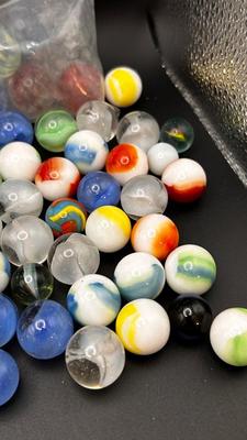 2 UNOPENED BAGS OF MARBLES AND SOME MISC