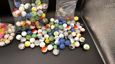2 UNOPENED BAGS OF MARBLES AND SOME MISC