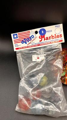 3 UNOPENED BAGS OF MARBLES AND A FEW LIKE MARBLES