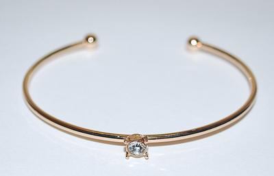 Single 4-Prong Round Clear Stone BRACELET (2½" Opening) on an OPEN-ENDED Gold Tone Setting