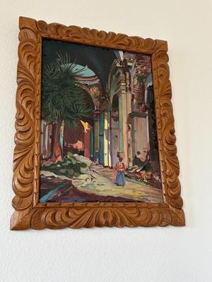 Painting in carved wooden frame
