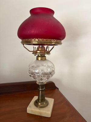 Red shade table oil lamp