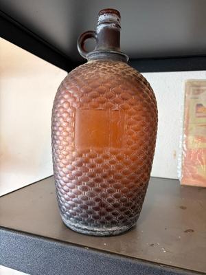 Brown one gallon glass jug