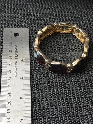 unbranded vintage gold-tone stretch bracelet with faux red gemstones.