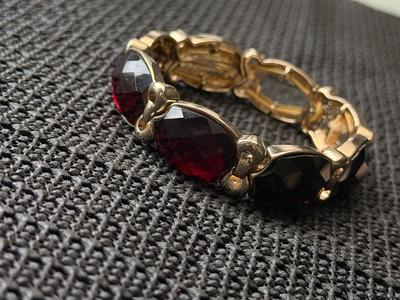 unbranded vintage gold-tone stretch bracelet with faux red gemstones.