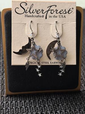 pair of Silver Forest Moon & Star layered linear earrings with a silver-tone finish and blue enamel accents.