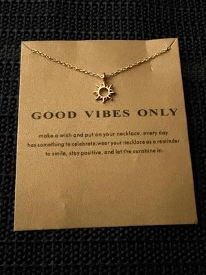 gold tone sun pendant necklace with a "Good Vibes Only" message card.