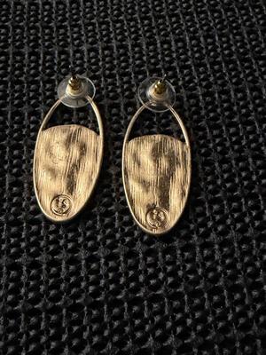Gold tone dangle fashion earrings marked TS