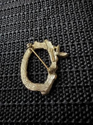 vintage Sarah Coventry gold-tone letter "C" initial pin brooch, featuring a vine branch or bamboo design.