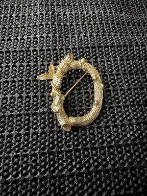 vintage Sarah Coventry gold-tone letter "C" initial pin brooch, featuring a vine branch or bamboo design.