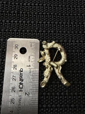 vintage Sarah Coventry initial "R" brooch pin, featuring a gold-tone metal design shaped like branches and leaves.