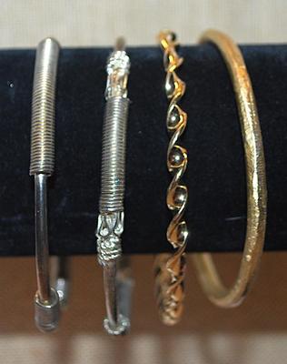 Collection of 4 BRACELETS (-2½"+ Opening) with Silver "Springs" and Brushed and Swirls Gold Tone Settings