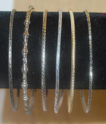 Collection of 6 BANGLE BRACELETS (2½" Opening) with an Assortment of Silver Tone Finishes & Graphics