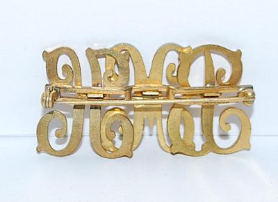 Gold Colored "BMK" BROOCH (2" x 1") on a Gold Tone Setting