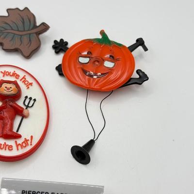 LOT 238J: 1980s Hallmark "When You're Hot, You're Hot!" Devil Pin, Pull String Plastic Pumpkin w/ Glasses & More