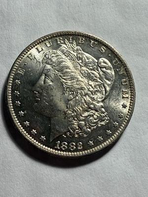 1882-O UNCIRCULATED CONDITION VERY LIGHTLY TONED OBV MORGAN SILVER DOLLAR.