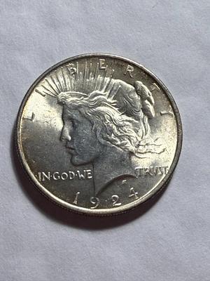 1924-P UNCIRCULATED CONDITION PEACE SILVER DOLLAR AS PICTURED.