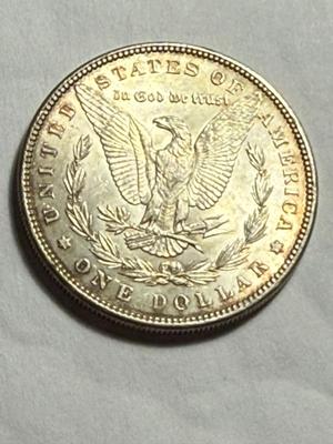 1885-P UNCIRCULATED LIGHTLY TONED MORGAN SILVER DOLLAR AS PICTURED.