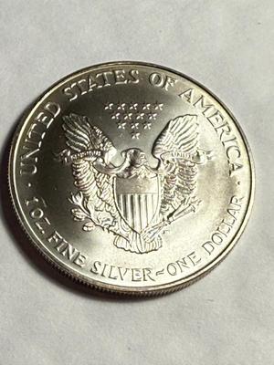 1997 CHOICE UNCIRCULATED CONDITION ALBUM TONED SILVER EAGLE DOLLAR AS PICTURED.