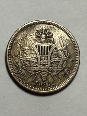 Scarce 1865-R Guatemala 2 Reales Silver Coin in VF Condition as Pictured.