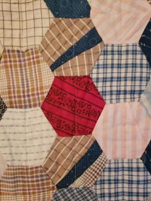 Vintage hand pieced machine quilted hexagon quilt.