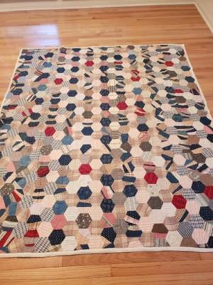 Vintage hand pieced machine quilted hexagon quilt.