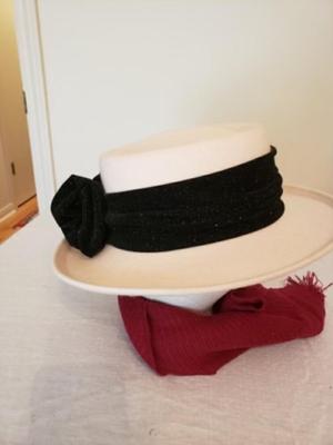 Women's cream colored fedora hat with a black ribbon and bow